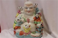 A Ceramic Chinese Buddha with Children