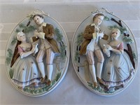 Pair of bisque wall plaques of colonial couple