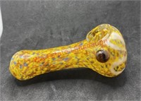 Glass pipe with blue yellow and brown dots and a