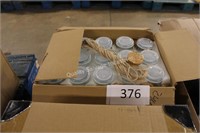 box of small glass jars with lids