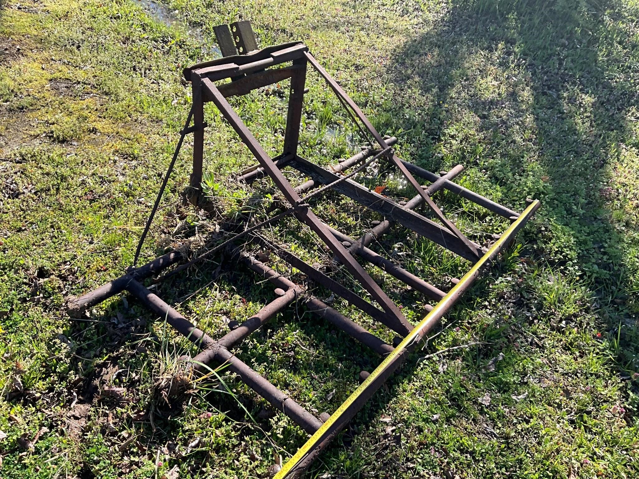 Home made harrow with railroad spikes