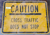 "CAUTION: CROSS TRAFFIC DOES NOT STOP" STREET SIGN