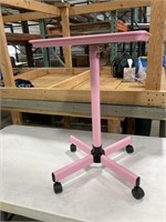 Pink adjustable table on wheels