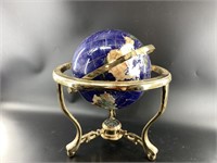 Beautiful semi-precious stone inlaid globe on a be