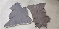 Pair of faux leather rugs