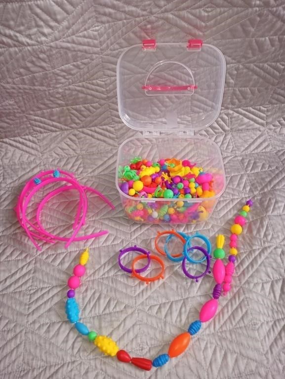 Girls play beads. Make headbands, bracelets,