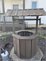 Wooden wishing well and watering can