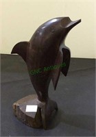 Carved out of solid wood dolphin sculpture