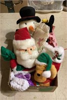 Box of stuffed toys includes a Santa Claus, a