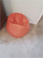 Small orange Bean bag chair.