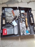 black carry case of mostly chainsaw tools