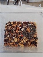 Plastic container of mostly wooden beads