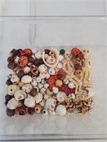 Plastic container of unusual skull beads
