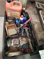 Black low tub of tools and hardware and garage