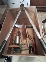 Box of gardening tools and a branch cutter