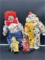 Lot of 4 clowns possibly porcelain