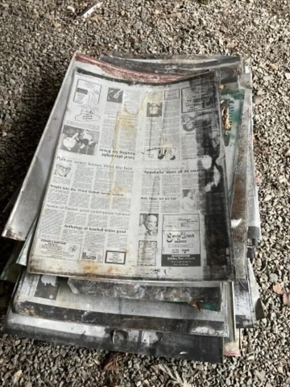 Pieces of tin with newspaper articles on them