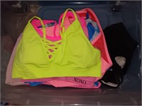 Bin full of sports bras, mostly extra large and