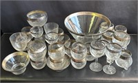 Large group of silver-rimmed glasses & bowls