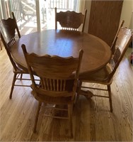 48" round oak table, 1 leaf, 6 pressed back chairs