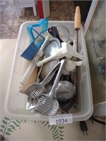 Clear tub of kitchen utensils