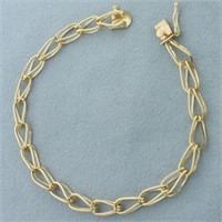 Double Tapered Loop Link Charm Bracelet in 14k Yel