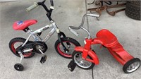 Red tricycle and Huffy bicycle with training