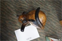 solid wood carved cat-leans over a ledge