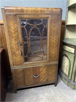1920s Waterfall style glass front cabinet with und
