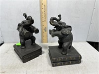 Pair of elephants standing on books bookends