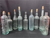 9 Clear Raised Design Wine Bottles various sizes