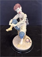 Sculpture of Boy putting on sock