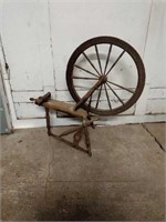 Antique wooden spinning wheel. Measures 45" tall.