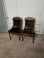 Two Antique-style green cushioned chairs. Each