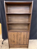 Tall dark brown bookshelf with sliding doors