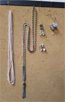 Three pairs of clip-on earrings and two necklaces