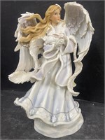 Angel figurine holding a rabbit. Made of resin.