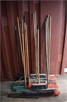 Collection of 12 shop brooms; as is