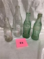 Four Coca-Cola Bottles