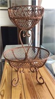 Two tier metal fruit basket.  Stands 21 inches