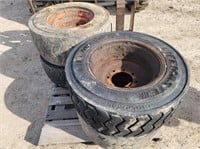 Set of skidloader tires on rims; 12-16.5