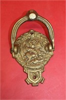 Brass doorknocker of St. George on Dragon