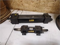 Two assorted small Parker hydraulic cylinders,