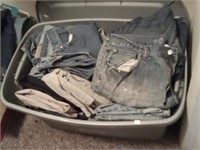 large group of men's denim blue jeans in tote