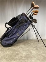 Nike golf bag with assorted old wood head golf