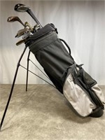 Waunakee golf bag with variety of putters, woods