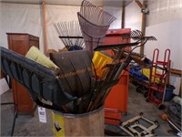 Barrel of hand tools, shovels , rakes