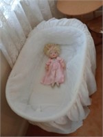 Wicker bassinet, cover and a sweet little doll