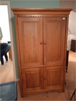 Wooden storage cabinet with a hanging bar and