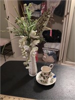 Arrangement in white vase and teacup and saucer